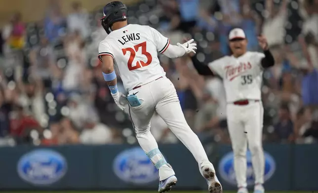 Minnesota Twins' Royce Lewis (23) runs the bases after hitting an two-run double during the seventh inning of a baseball game against the Los Angeles Angels, Wednesday, Sept. 11, 2024, in Minneapolis. (AP Photo/Abbie Parr)