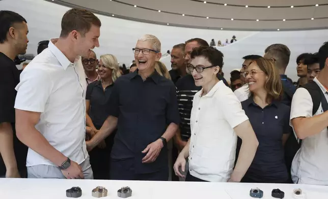 Apple CEO Tim Cook smiles with attendees after announcing new products at Apple headquarters Monday, Sept. 9, 2024, in Cupertino, Calif. (AP Photo/Juliana Yamada)