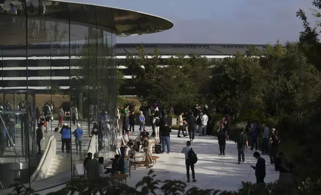 Attendees wait inside and outside the Steve Jobs Theater before an announcement of new products at Apple headquarters Monday, Sept. 9, 2024, in Cupertino, Calif. (AP Photo/Juliana Yamada)