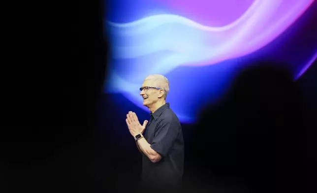 Apple CEO Tim Cook walks on the stage during an announcement of new products at Apple headquarters Monday, Sept. 9, 2024, in Cupertino, Calif. (AP Photo/Juliana Yamada)