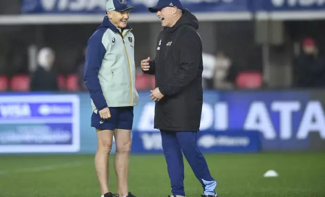 Australia coach Joe Schmidt, left, and Argentina coach Felipe Contepomi, talk before the start of a rugby championship test match between Argentina and Australia, in La Plata, Argentina, Saturday, Aug. 31, 2024. (AP Photo/Gustavo Garello)