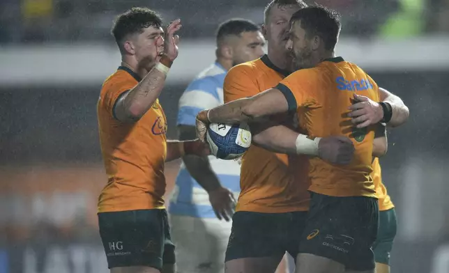 Australia's Jake Gordon, right, celebrates after scoring a try during a rugby championship test match against Argentina in La Plata, Argentina, Saturday, Aug. 31, 2024. (AP Photo/Gustavo Garello)