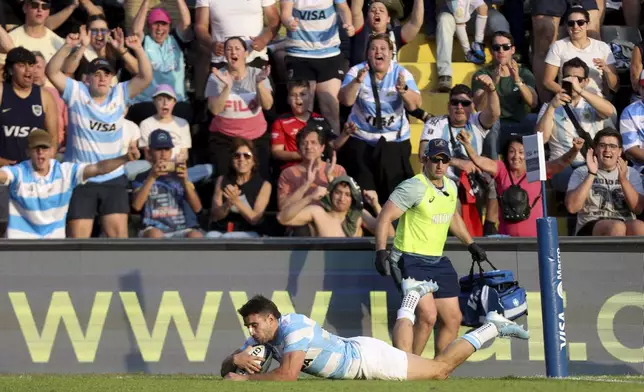 Argentina's Los Pumas Juan Cruz Mallia scores a try against Australia during a rugby championship test match between Argentina and Australia in Santa Fe, Argentina, Saturday, Sept. 7, 2024. (AP Photo/Mateo Occhi)