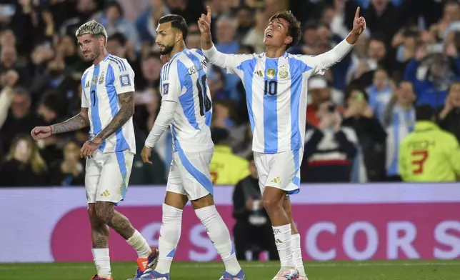 Argentina's Paulo Dybala, right, celebrates scoring his side's third goal against Chile during a qualifying soccer match for the FIFA World Cup 2026 in Buenos Aires, Argentina, Thursday, Sept. 5, 2024. (AP Photo/Gustavo Garello)