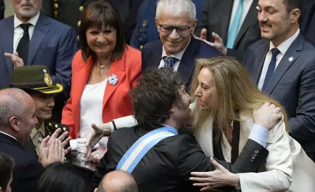 Argentina's President Javier Milei greets his sister Karina Milei as he arrives at Congress to present the 2025 budget in Buenos Aires, Argentina, Sunday, Sept. 15, 2024. (AP Photo/Natacha Pisarenko)