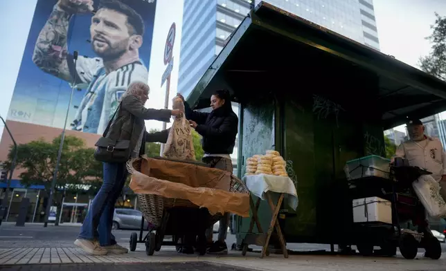 Veronica Vera, center, sells bread on the sidewalk in Buenos Aires, Argentina, Friday, Sept. 20, 2024. (AP Photo/Natacha Pisarenko)