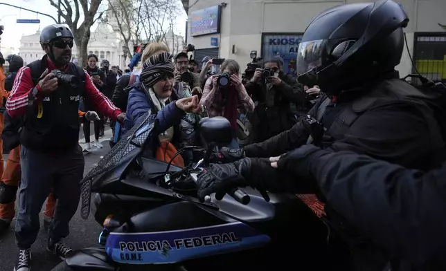 A woman scolds the police during protests against President Javier Milei's veto of a pension raise in Buenos Aires, Argentina, Wednesday, Sept. 11, 2024. (AP Photo/Natacha Pisarenko)