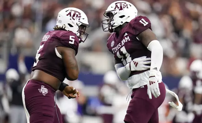 Texas A&amp;M defensive lineman Shemar Turner, left, and defensive lineman Nic Scourton react after a tackle during the first half of an NCAA college football game against Arkansas, Saturday, Sept. 28, 2024, in Arlington, Texas. (AP Photo/Julio Cortez)