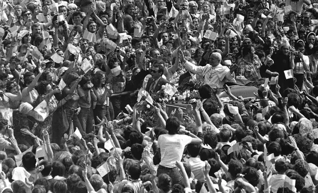 FILE - Pope John Paul II. stands in open car as he greets cheering crowd of believers, on the third day of the Pontiff's historical nine-day-visit to his homeland Poland, June 4, 1979 at Czestochowa near the famous monastery Jasna Gora. (AP Photo, File)