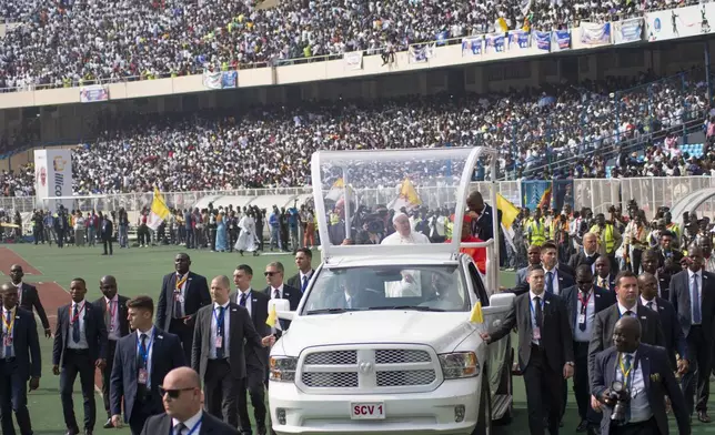 FILE - Pope Francis on the popemobile, waves at worshipers at the Martyrs' Stadium in Kinshasa, Congo, on Feb. 2, 2023. (AP Photo/Samy Ntumba Shambuyi, File)