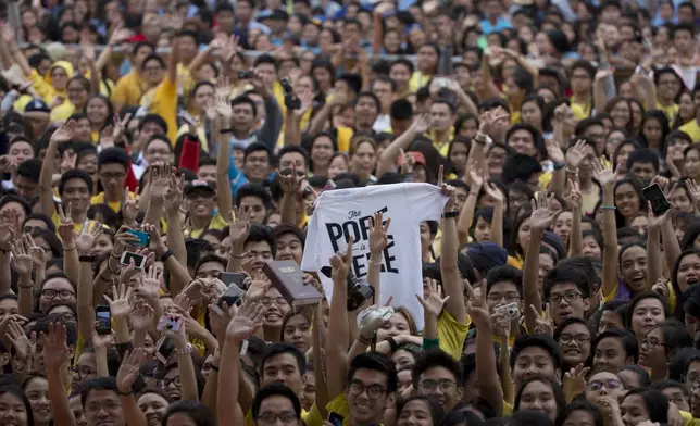 FILE - Young people wait for the arrival of Pope Francis in Santo Tomas University in Manila, Philippines, on Jan. 18, 2015. (AP Photo/Alessadra Tarantino, File)