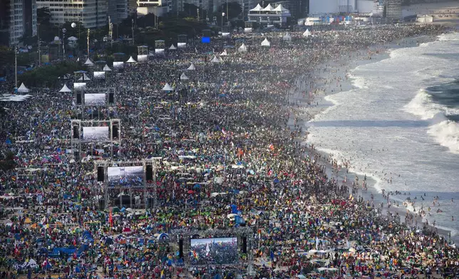 FILE - Pilgrims and residents gather on Copacabana beach before the arrival of Pope Francis for World Youth Day in Rio de Janeiro, Brazil, on July 27, 2013. (AP Photo/Felipe Dana, File)