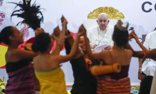 Pope Francis looks at traditional dancers as he arrives at the Centro de Convenções in Díli, East Timor, Wednesday, Sept. 11, 2024, for a meeting with young people. In East Timor Francis had to negotiate perhaps the most sensitive issue of his trip to Asia and Oceania clouding the visit: the case of Bishop Carlos Ximenes Belo, the revered national hero who won the Nobel Peace Prize for his nonviolent independence campaign. (AP Photo/Gregorio Borgia)