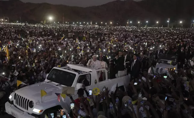 Pope Francis leaves after leading a holy mass at Tasitolu Park in Dili, East Timor, Tuesday, Sept. 10, 2024. With half of East Timor's population gathered at a seaside park, Francis couldn't help but oblige them with a final good night and languid loops in his popemobile, long after the sun had set and cellphone screens lighted the field. (AP Photo/Firdia Lisnawati)