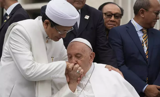 Pope Francis, bids farewell to The Grand Imam Nasaruddin Umar, left, as he leaves after signing the "Joint Declaration of Istiqlal 2024" at the Istiqlal Mosque in Jakarta, Thursday, Sept. 5, 2024. Even in the most delicate moment of his Asian trip in Jakarta, at Southeast Asia's biggest mosque, Francis threw protocol aside and kissed the hand of the grand imam and brought it to his cheek in gratitude. (AP Photo/Gregorio Borgia)