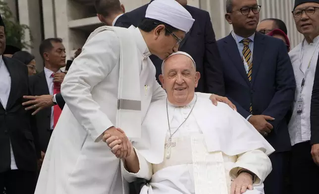 The Grand Imam Nasaruddin Umar, left, bids farewell to Pope Francis, as he leaves after signing the "Joint Declaration of Istiqlal 2024" at the Istiqlal Mosque in Jakarta, Thursday, Sept. 5, 2024. (AP Photo/Gregorio Borgia)