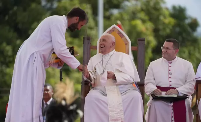 Pope Francis, talks with Father Martin Prado, a missionary of the Institute of the Incarnate Word, left, during a meeting with faithful in Vanimo, Papua New Guinea, Sunday, Sept. 8, 2024. (AP Photo/Gregorio Borgia)