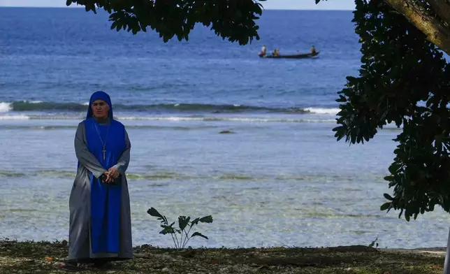 A nun waits for the arrival of Pope Francis in Vanimo, Papua New Guinea, Sunday, Sept. 8, 2024. (AP Photo/Gregorio Borgia)