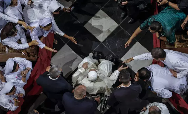 Pope Francis is greeted as he arrives at the Jakarta Cathedral in Jakarta, Indonesia, Wednesday, Sept. 4, 2024. (Yasuyoshi Chiba /Pool Photo via AP)