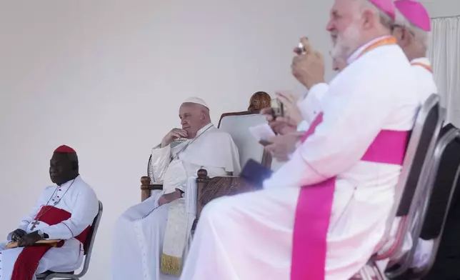 Pope Francis, second left, sits for a meeting with young people in the Sir John Guise Stadium in Port Moresby, Papua New Guinea, Monday, Sept. 9, 2024. (AP Photo/Mark Baker)