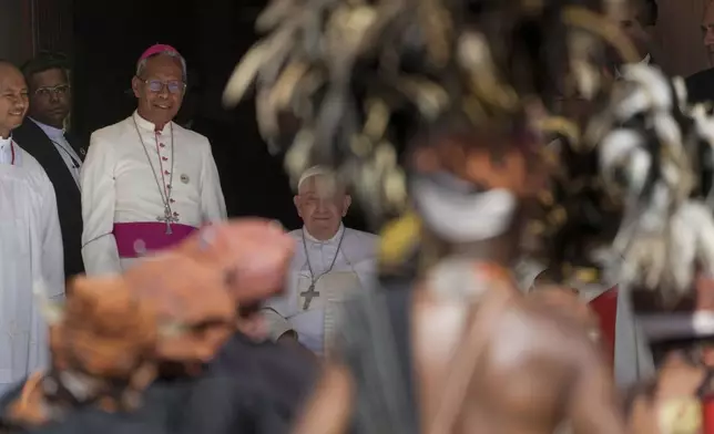 Pope Francis is welcomed by the President of East Timor Episcopal Conference Norberto do Amaral, third from left, as he arrives at a meeting with bishops, priests, deacons, consecrated persons, seminarians and catechists in the Cathedral of the Immaculate Conception in Dili, East Timor, Tuesday, Sept. 10, 2024. (AP Photo/Gregorio Borgia)