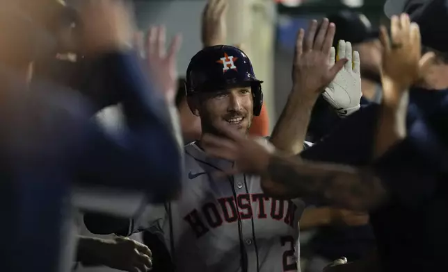 Houston Astros' Alex Bregman celebrates in the dugout after hitting a home run during the third inning of a baseball game against the Los Angeles Angels in Anaheim, Calif., Friday, Sept. 13, 2024. Kyle Tucker also scored. (AP Photo/Ashley Landis)