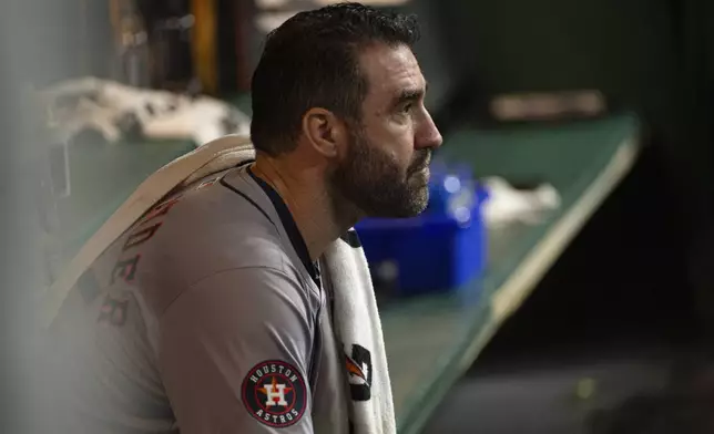 Houston Astros starting pitcher Justin Verlander sits in the dugout during the fifth inning of a baseball game against the Cleveland Guardians in Cleveland, Saturday, Sept. 28, 2024. (AP Photo/Phil Long)