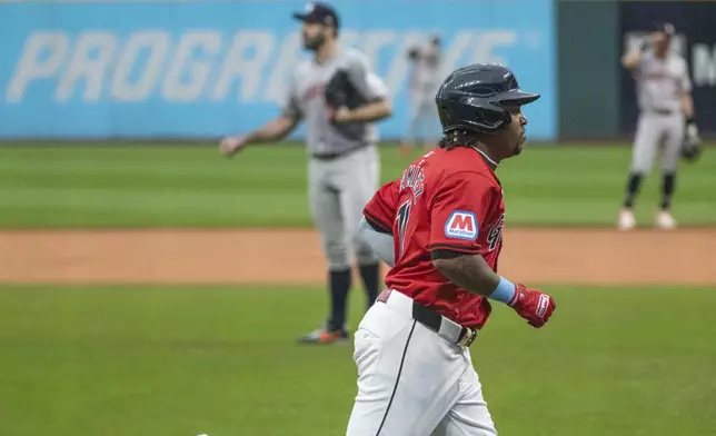 Cleveland Guardians' Jose Ramirez, front, rounds the bases after hitting a two-run home run off Houston Astros starting pitcher Justin Verlander, back left, during the first inning of a baseball game in Cleveland, Saturday, Sept. 28, 2024. (AP Photo/Phil Long)