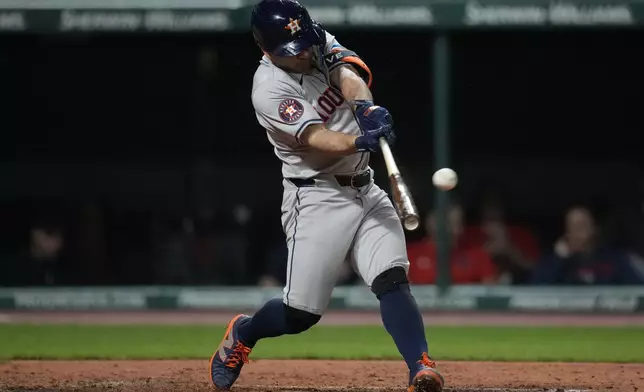 Houston Astros' Jose Altuve doubles in the fourth inning of a baseball game against the Cleveland Guardians in Cleveland, Friday, Sept. 27, 2024. (AP Photo/Sue Ogrocki)