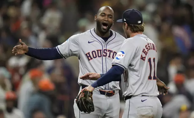 Houston Astros designated hitter Yordan Alvarez, center, celebrates with teammate third baseman Grae Kessinger after the Astros defeated the San Diego Padres 4-3 in a baseball game Tuesday, Sept. 17, 2024, in San Diego. (AP Photo/Gregory Bull)