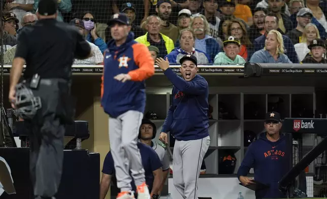 Houston Astros hitting coach Alex Cintron, right, gestures as he is ejected by home plate umpire Brian O'Nora, left, during the sixth inning a baseball game against the San Diego Padres, Monday, Sept. 16, 2024, in San Diego. (AP Photo/Gregory Bull)