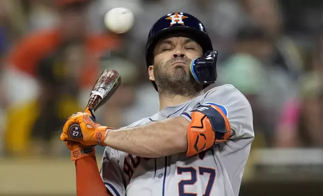 Houston Astros' Jose Altuve moves away from a high pitch while batting during the eighth inning of a baseball game against the San Diego Padres, Tuesday, Sept. 17, 2024, in San Diego. (AP Photo/Gregory Bull)