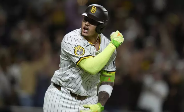 San Diego Padres' Manny Machado celebrates after hitting a two-run home run during the sixth inning of a baseball game against the Houston Astros, Tuesday, Sept. 17, 2024, in San Diego. (AP Photo/Gregory Bull)