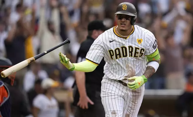 San Diego Padres' Manny Machado tosses his bat after hitting a home run during the sixth inning of a baseball game against the Houston Astros Wednesday, Sept. 18, 2024, in San Diego. (AP Photo/Gregory Bull)