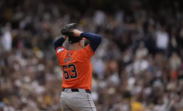 Houston Astros relief pitcher Kaleb Ort looks on as San Diego Padres' Donovan Solano rounds the bases after giving up his third home run in three consecutive batters to Solano during the eighth inning of a baseball game Wednesday, Sept. 18, 2024, in San Diego. (AP Photo/Gregory Bull)