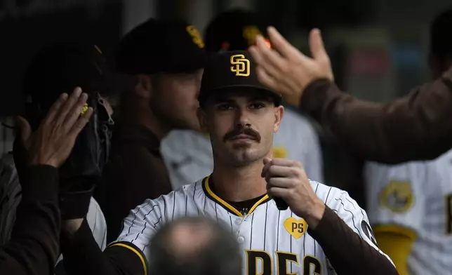 San Diego Padres starting pitcher Dylan Cease is greeted in the dugout after exiting during the ninth inning of a baseball game against the Houston Astros Wednesday, Sept. 18, 2024, in San Diego. (AP Photo/Gregory Bull)