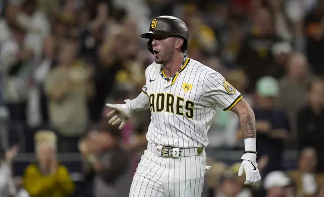 San Diego Padres' Jackson Merrill celebrates after hitting a home run during the fourth inning of a baseball game against the Houston Astros, Monday, Sept. 16, 2024, in San Diego. (AP Photo/Gregory Bull)