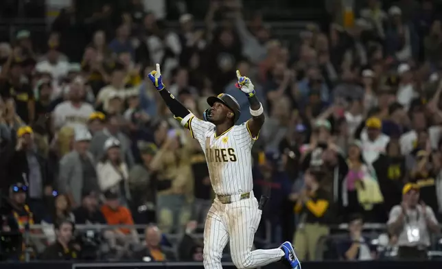 San Diego Padres' Jurickson Profar celebrates after hitting a home run during the eighth inning of a baseball game against the Houston Astros, Monday, Sept. 16, 2024, in San Diego. (AP Photo/Gregory Bull)