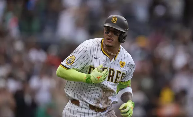 San Diego Padres' Manny Machado celebrates after hitting a home run during the sixth inning of a baseball game against the Houston Astros Wednesday, Sept. 18, 2024, in San Diego. (AP Photo/Gregory Bull)