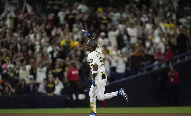 San Diego Padres' Jurickson Profar celebrates after hitting a home run during the eighth inning of a baseball game against the Houston Astros, Monday, Sept. 16, 2024, in San Diego. (AP Photo/Gregory Bull)