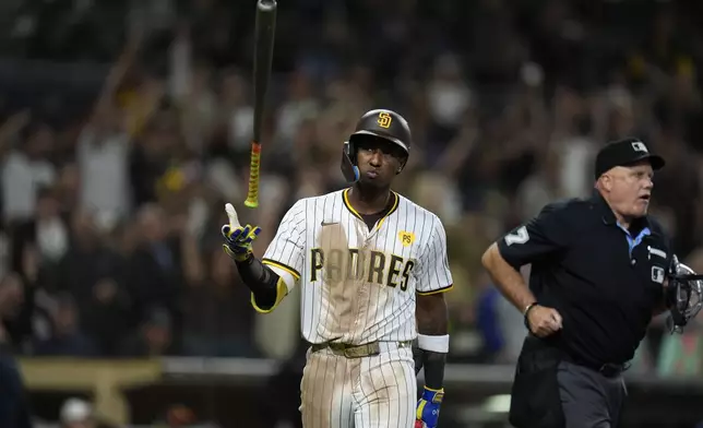 San Diego Padres' Jurickson Profar tosses his bat after hitting a home run during the eighth inning of a baseball game against the Houston Astros, Monday, Sept. 16, 2024, in San Diego. (AP Photo/Gregory Bull)