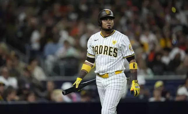 San Diego Padres' Luis Arraez walks toward the dugout after striking out during the second inning of a baseball game against the Houston Astros, Monday, Sept. 16, 2024, in San Diego. (AP Photo/Gregory Bull)