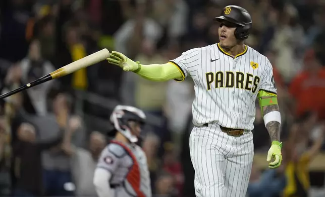 San Diego Padres' Manny Machado tosses his bat after hitting a two-run home run during the sixth inning of a baseball game against the Houston Astros, Tuesday, Sept. 17, 2024, in San Diego. (AP Photo/Gregory Bull)