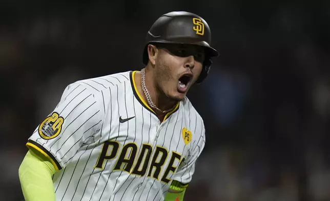 San Diego Padres' Manny Machado celebrates after hitting a two-run home run during the sixth inning of a baseball game against the Houston Astros, Tuesday, Sept. 17, 2024, in San Diego. (AP Photo/Gregory Bull)