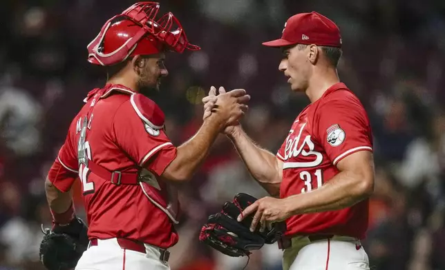 Cincinnati Reds pitcher Brent Suter (31) and catcher Luke Maile (22) celebrate after winning a baseball game against the Houston Astros, ,Wednesday, Sept. 4, 2024, in Cincinnati. (AP Photo/Carolyn Kaster)