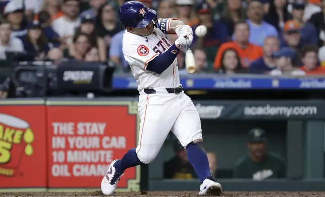 Houston Astros' Jose Altuve connects for his one-run RBI single against the Oakland Athletics during the seventh inning of a baseball game, Tuesday, Sept. 10, 2024, in Houston. (AP Photo/Michael Wyke)