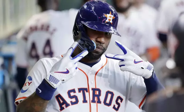 Houston Astros' Jason Heyward mugs for the dugout camera as he celebrates his two-run home run against the Oakland Athletics during the second inning of a baseball game Thursday, Sept. 12, 2024, in Houston. (AP Photo/Michael Wyke)