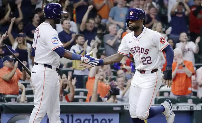 Houston Astro' Yordan Alvarez and pinch runner Jason Heyward (22) celebrate Heyward's score on the RBI single by Jose Altuve against the Oakland Athletics during the seventh inning of a baseball game, Tuesday, Sept. 10, 2024, in Houston. (AP Photo/Michael Wyke)