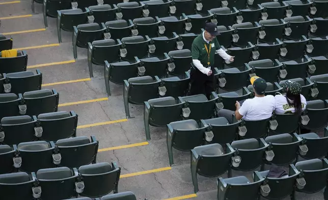 Leland Anderson says hello to fans attending a baseball game between the Colorado Rockies and the Oakland Athletics, Wednesday, May 22, 2024, in Oakland, Calif. (AP Photo/Godofredo A. Vásquez)