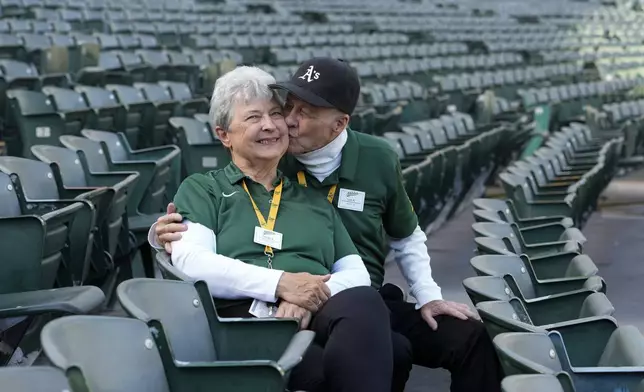 Leland Anderson, right, kisses his wife Sandy while being photographed at Oakland Coliseum, Tuesday, May 21, 2024, in Oakland, Calif. (AP Photo/Godofredo A. Vásquez)